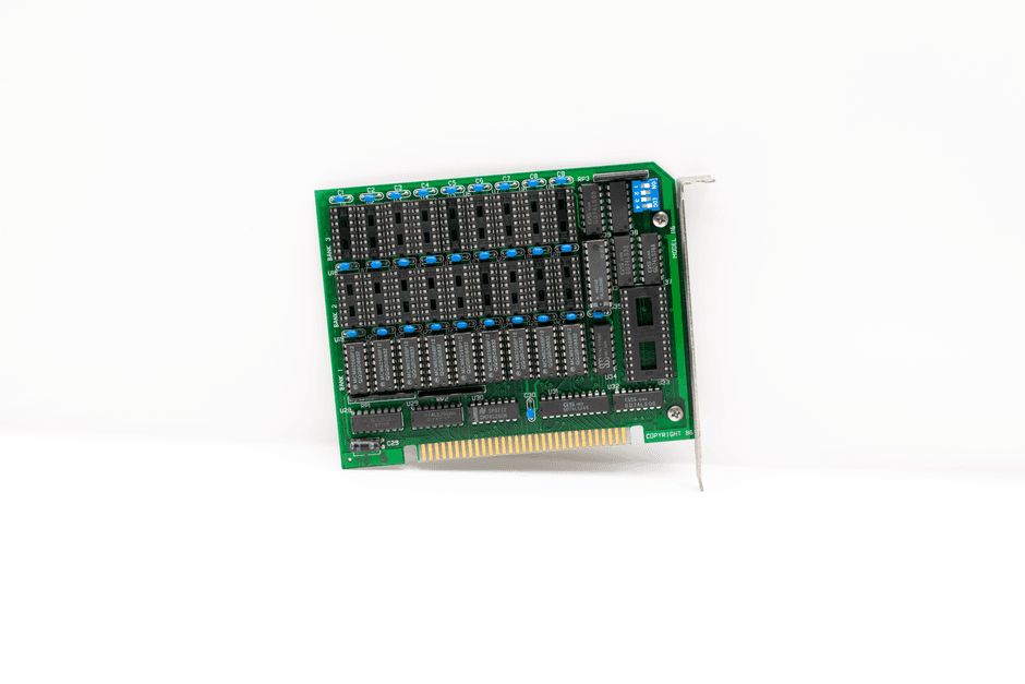 A vintage circuit board with protruding components and connectors on a white background.